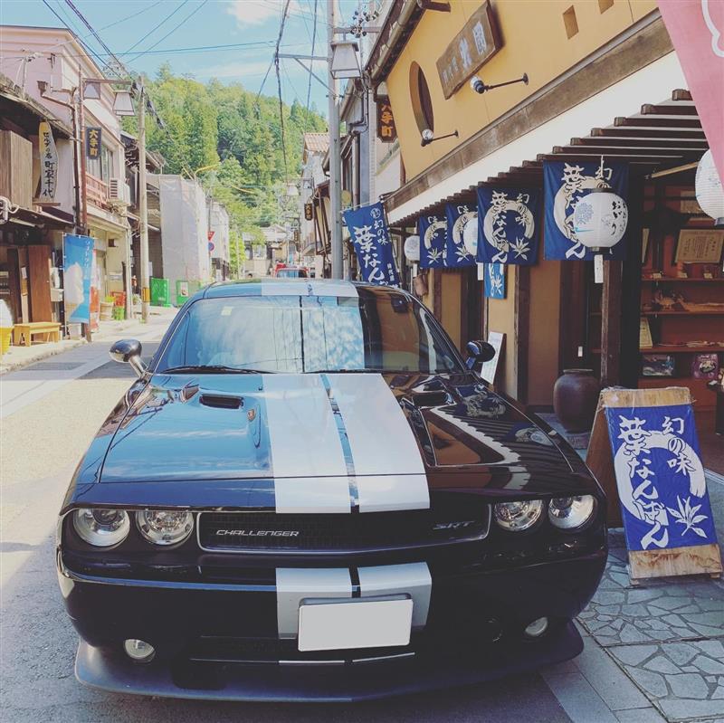 Blue Dodge Challenger with Double White Stripe Down the Middle